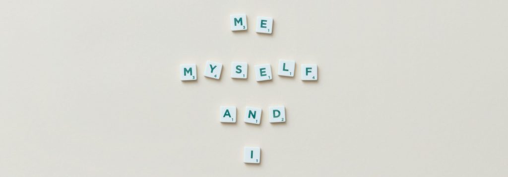 Scrabble tiles spelling out the words "me," "myself," and "I."